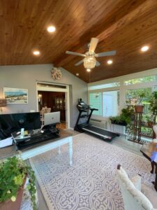 Interior photo of a sunroom answering some of the questions people have when considering adding on a sunroom to their home. 