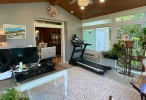 Ideas for sunrooms - this family is using their sunroom to fulfill multiple purposes including workout room and office.